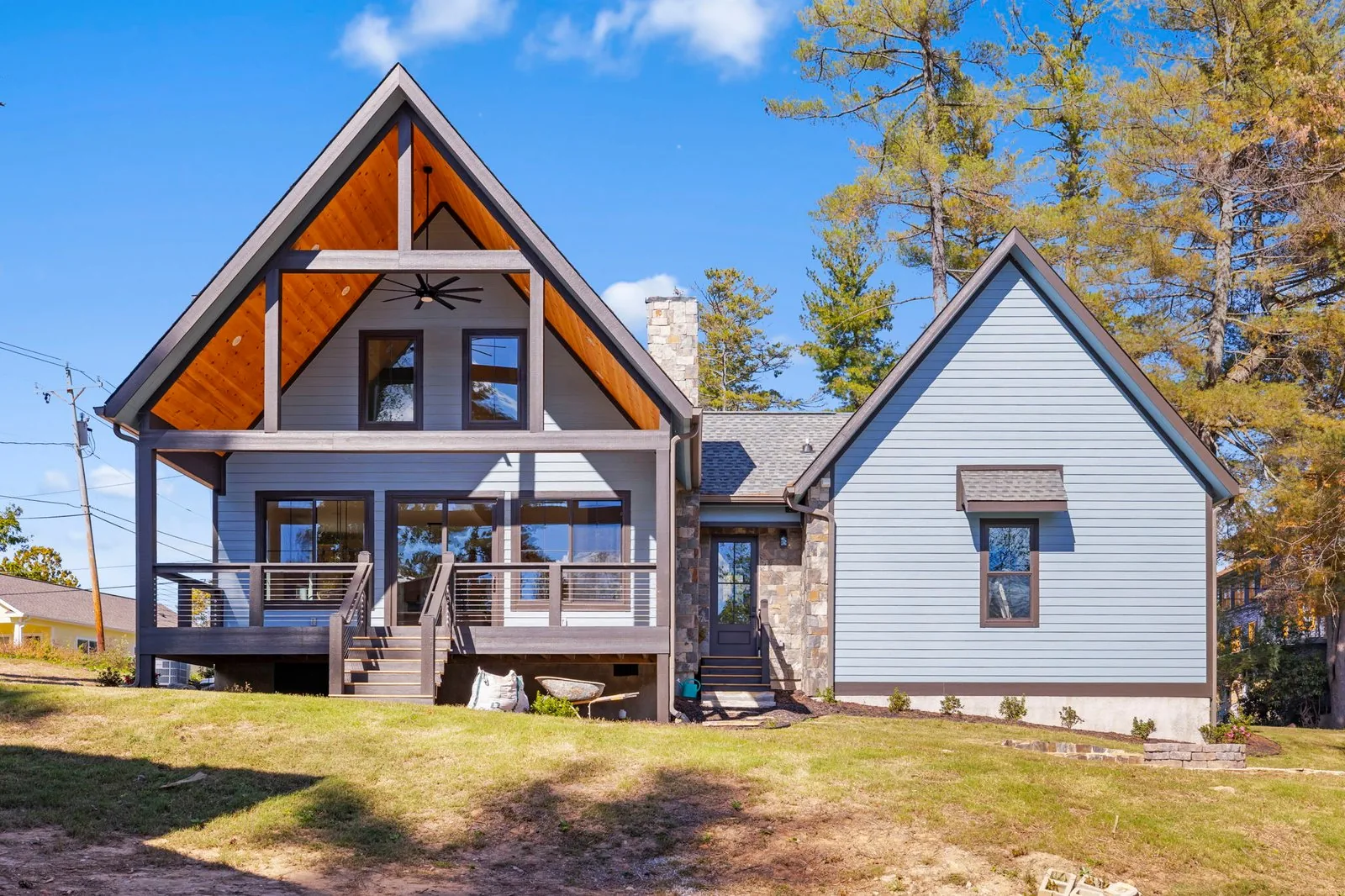 Custom mountain home exterior with timber accents and a stone base
