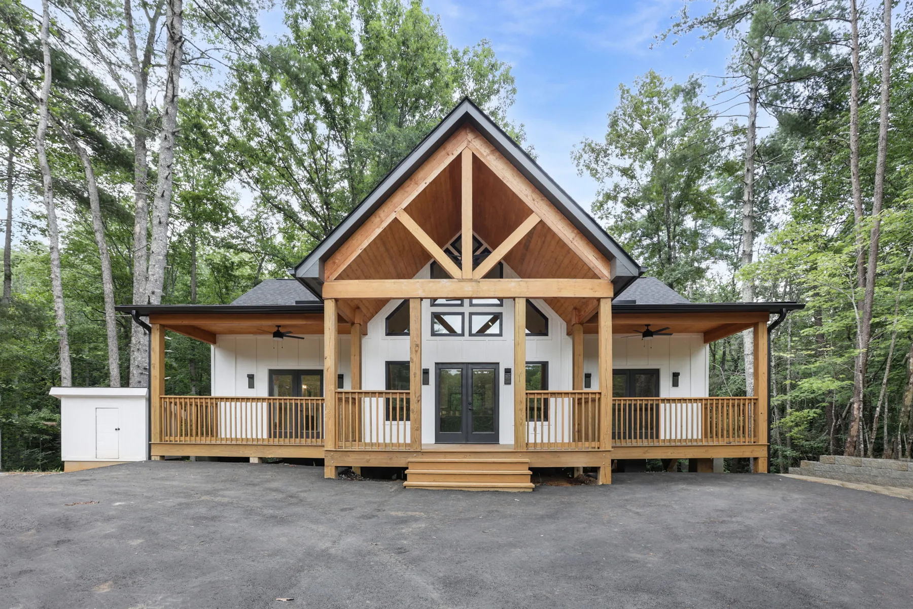 Timber truss gable and covered porch on a custom home in Lake Lure NC