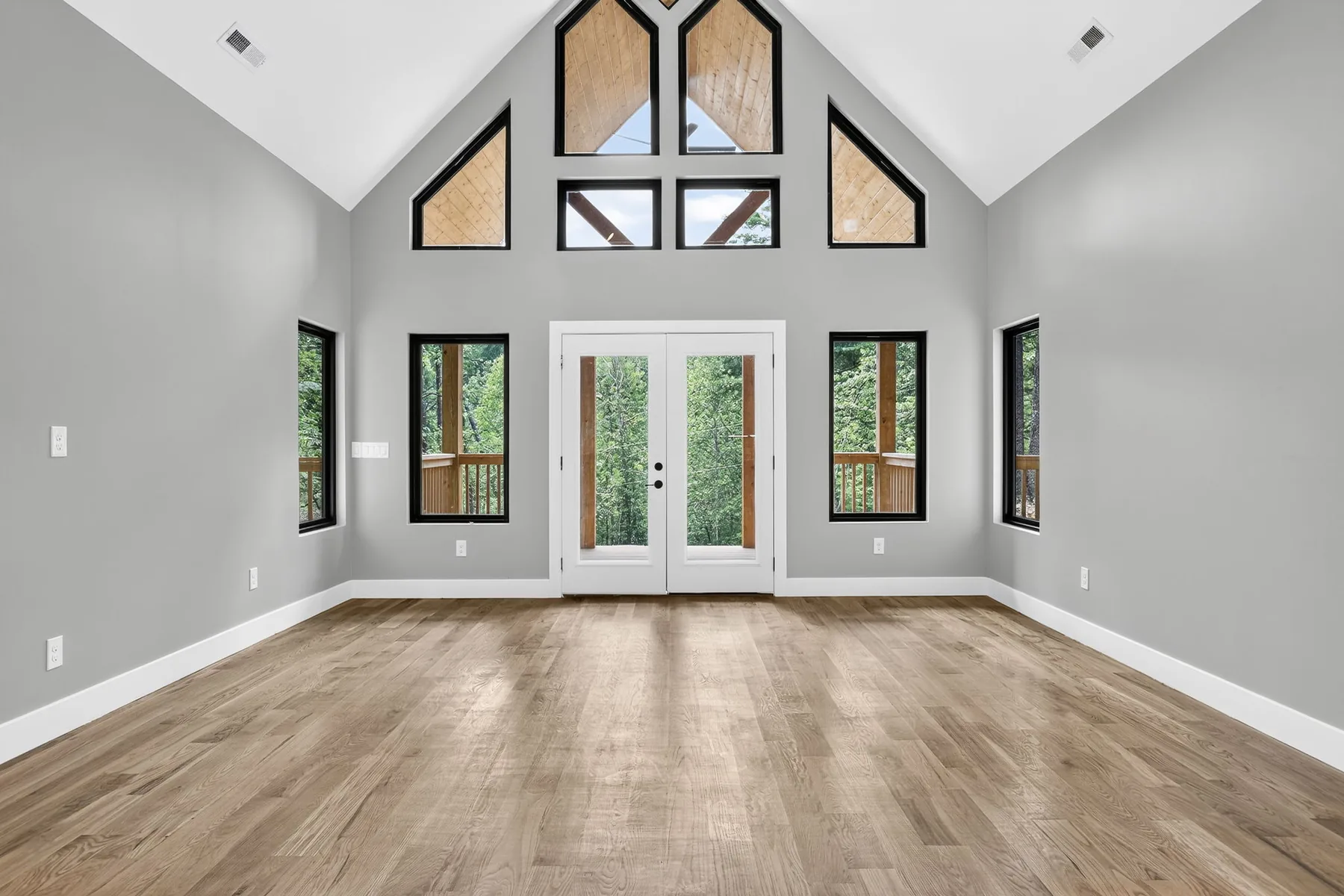Vaulted great room with a glazed gable end and hardwood floors, Lake Lure NC