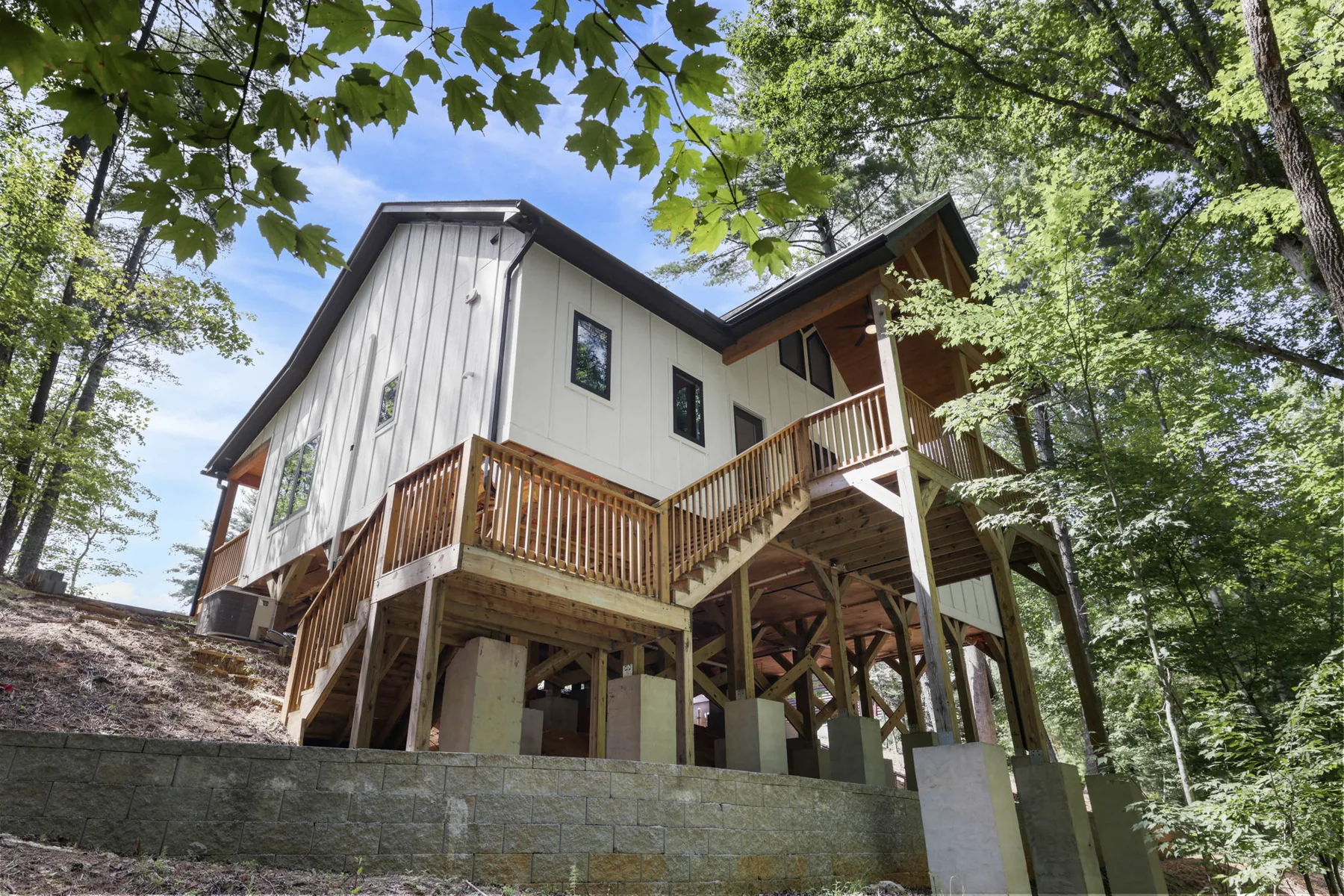 Custom home built on tall structural piers over a steep hillside lot in Lake Lure, NC