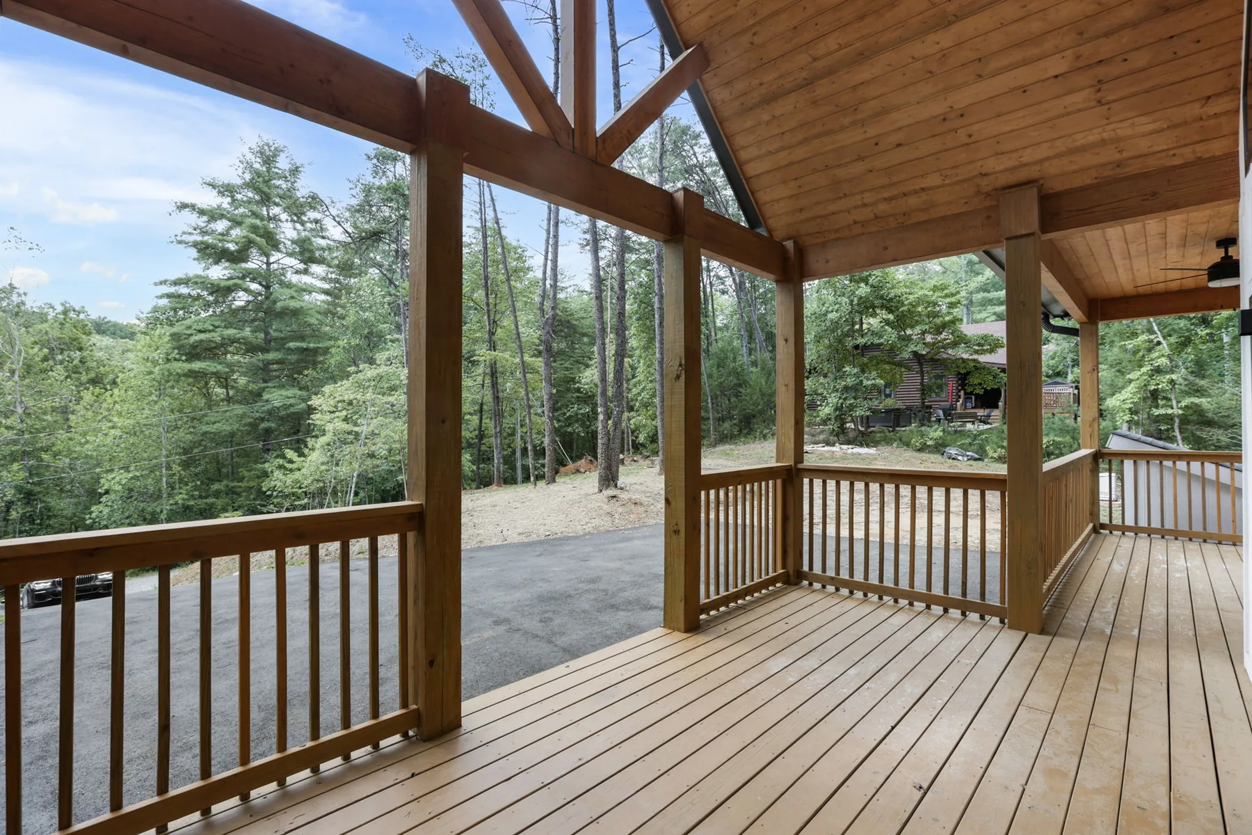 Covered porch with timber posts and a stained wood ceiling, Lake Lure NC